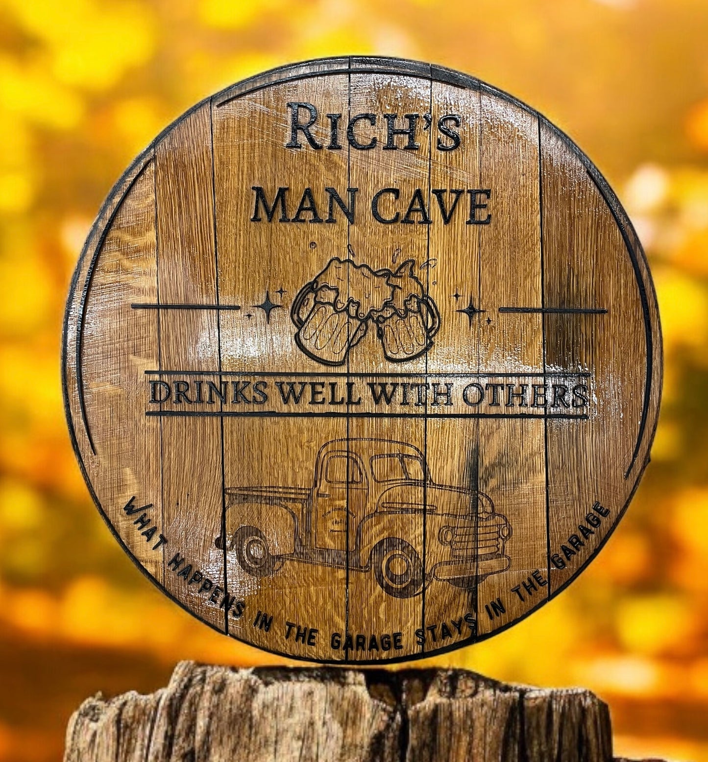 Wooden barrel with engraved text and graphics on a blurred yellow background