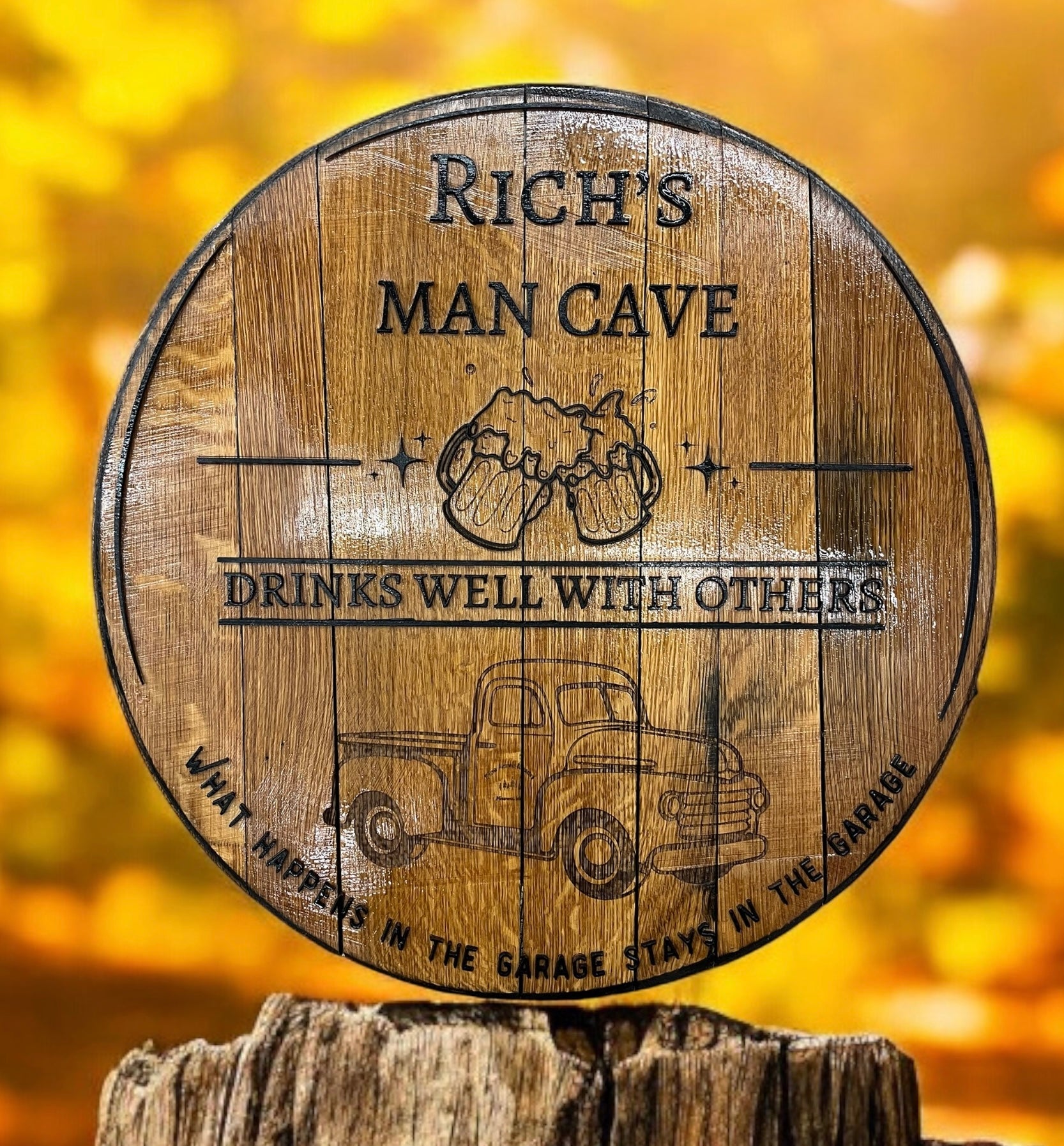 Wooden barrel with engraved text and graphics on a blurred yellow background